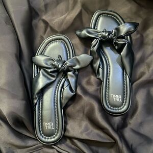 Black bow flip flops